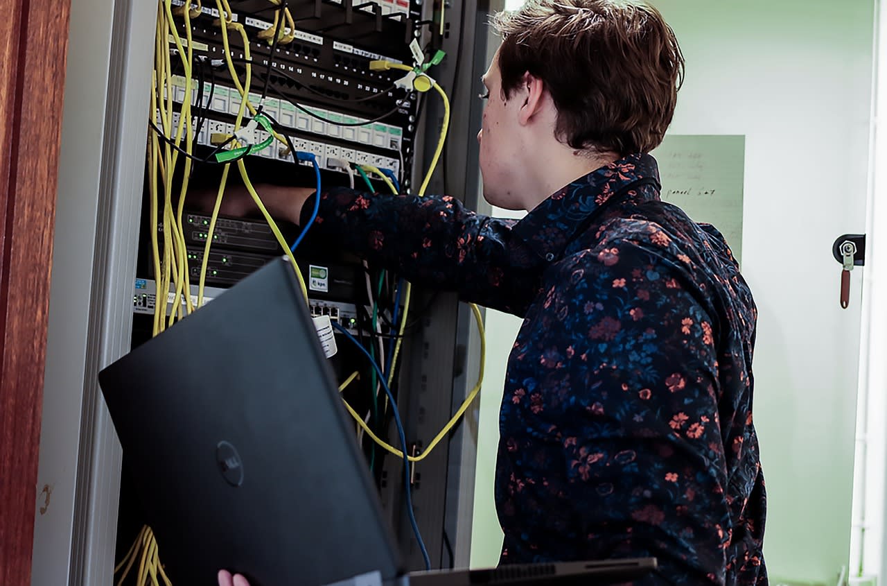 A technician performing maintenance on a hosting server.
